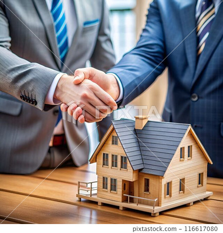 close up of businessman shaking hands with house 116617080