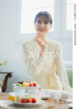 A woman eating sweets at a cafe A woman eating sweets at a cafe 116617202