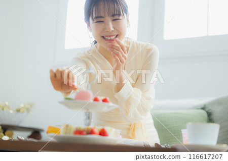 一個女人在咖啡館吃糖果 116617207