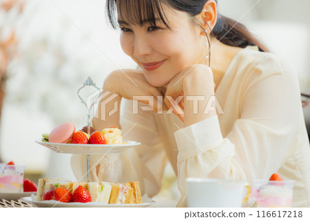 一個女人在咖啡館吃糖果 116617218