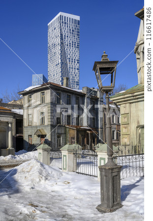 21st-century skyscraper and scenery of 19 century lantern and reconstruction of old Moscow street 21st-century skyscraper and scenery of 19 century lantern and reconstruction of old Moscow street 116617486
