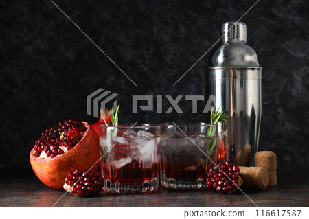 Red cocktail with fresh pomegranate on a dark background Red cocktail with fresh pomegranate on a dark background 116617587