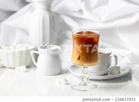 Iced coffee with cream and cup of black coffee. 116617931