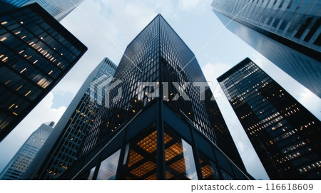 The towering facade of skyscrapers against a dimming sky, showcasing urban architecture. 116618609