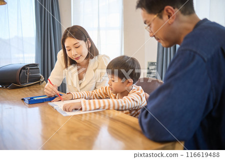 Father and mother watching their child study 116619488