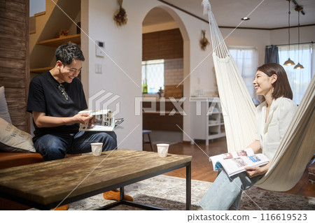 A young couple relaxing in the living room A young couple relaxing in the living room 116619523