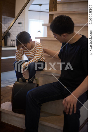 A boy who doesn't want to go to school and his father encouraging him A boy who doesn't want to go to school and his father encouraging him 116619565
