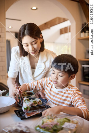 Mother and son arranging side dishes Mother and son arranging side dishes 116619598