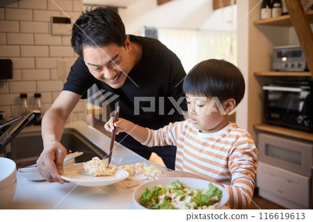 Father and son serving side dishes 116619613