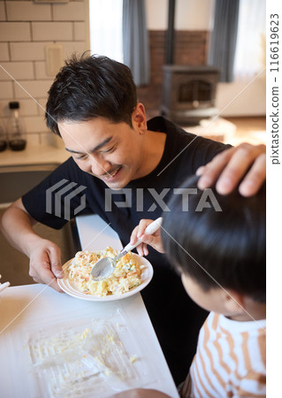 Father and son serving side dishes 116619623
