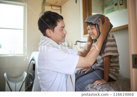 Father wiping his son's head with a towel Father wiping his son's head with a towel 116619868