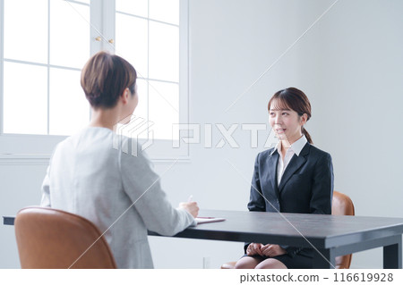 A woman undergoing a company interview during a job search 116619928