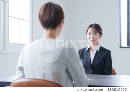 A woman undergoing a company interview during a job search 116619932