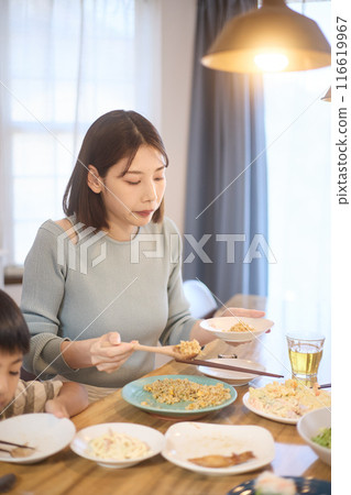 Mother serving rice 116619967