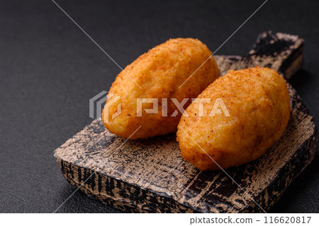 Delicious chicken Kiev or potato cutlets with salt, spices and herbs 116620817