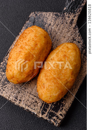 Delicious chicken Kiev or potato cutlets with salt, spices and herbs 116620818