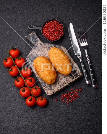 Delicious chicken Kiev or potato cutlets with salt, spices and herbs 116620825
