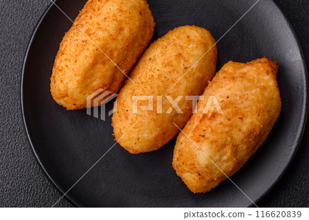 Delicious chicken Kiev or potato cutlets with salt, spices and herbs Delicious chicken Kiev or potato cutlets with salt, spices and herbs 116620839