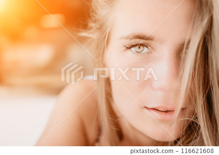 Happy woman portrait in cafe. Boho chic fashion style. Outdoor photo of young happy woman with long hair, sunny weather outdoors sitting in modern cafe. 116621608