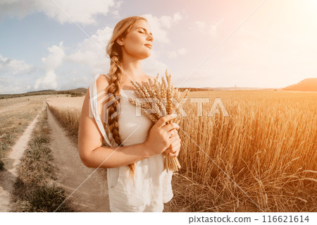 Woman wheat field. Agronomist, Woman farmer check golden ripe barley spikes in cultivated field. Closeup of female hand on plantation in agricultural crop management concept. Slow motion 116621614