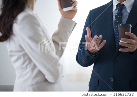 Businessmen having a coffee break and chatting in the office. Faceless manager or businessperson 116621728