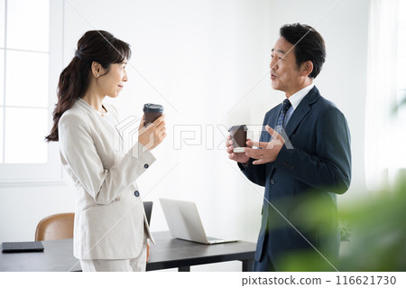 Businessman taking a coffee break in the office Image of a manager or business owner Businessman taking a coffee break in the office Image of a manager or business owner 116621730