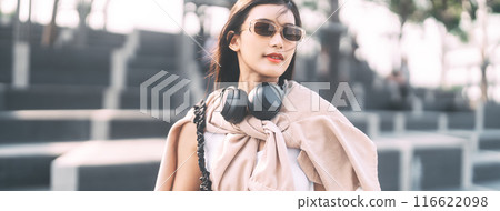 Portrait of youth asian woman teenager gen z wearing headphone and sunglasses 116622098