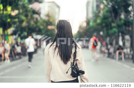 Rear view of woman walking at shopping street in city gen z lifestyles 116622119