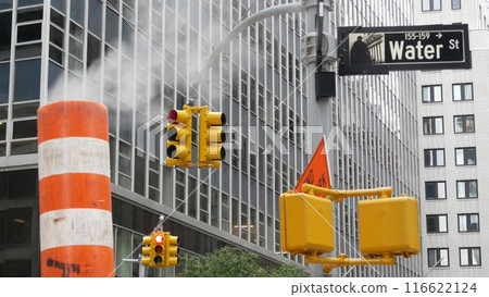Steam vapor vented, New York City street steam system, orange vapour tube stack. Hot smoke from pipe 116622124