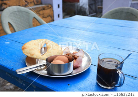 Gurung bread and eggs with the nepali black tea, a traditional Nepali breakfast in the lodge inside the poonhill trekking circle 116622212