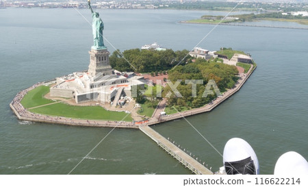 New York City doors off helicopter flight, Manhattan USA. Feet in sneakers, legs in shoes selfie pov New York City doors off helicopter flight, Manhattan USA. Feet in sneakers, legs in shoes selfie pov 116622214