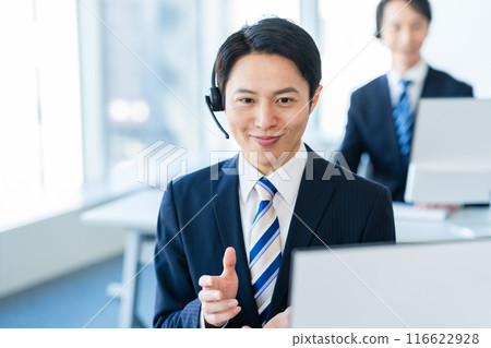 Japanese male operator working in an office Japanese male operator working in an office 116622928