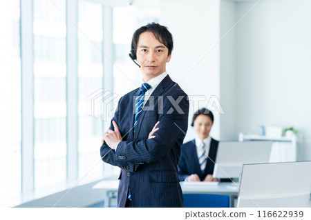 Japanese male operator working in an office Japanese male operator working in an office 116622939