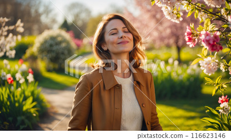 Portrait of a beautiful European woman posing in springtime in the park, close-up view of a cheerful handsome Caucasian white middle aged woman in an outdoor park. Ai Generated 116623146