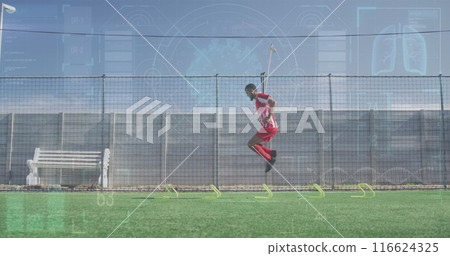 Image of interface processing data over male footballer training on pitch jumping hurdles Image of interface processing data over male footballer training on pitch jumping hurdles 116624325