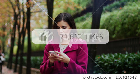 Image of social media like notification over caucasian woman using smartphone in park Image of social media like notification over caucasian woman using smartphone in park 116624548