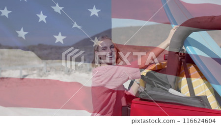 Image of flag of usa over caucasian woman by beach 116624604
