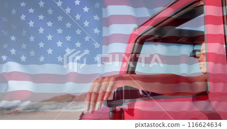 Image of flag of usa over happy african american woman in car by beach in summer 116624634