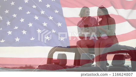 Image of flag of usa over happy diverse women on car by beach in summer 116624807