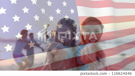 Image of flag of usa over happy diverse women on beach in summer 116624846