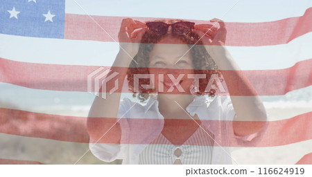 Image of flag of usa over happy diverse friends on beach in summer 116624919
