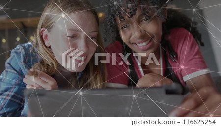 Image of network of connections over diverse women using tablet 116625254