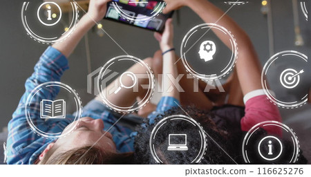 Image of icons and data processing over diverse women using smartphone 116625276