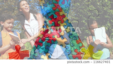 This image depicts colorful puzzle pieces moving over happy playing children This image depicts colorful puzzle pieces moving over happy playing children 116627401