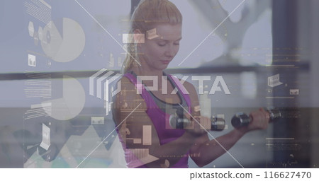 A fit woman lifting dumbbells in a gym in high quality 4k format 116627470