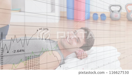 Image of graphs and numbers on caucasian physiotherapist stretching leg of man in therapy center 116627530