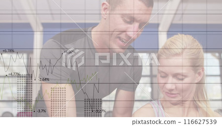 Image of graphs and numbers on caucasian male trainer helping woman in dumbbells exercise in gym 116627539