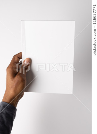 Biracial hand holding a blank white paper, with copy space Biracial hand holding a blank white paper, with copy space 116627771
