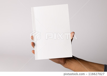 Biracial man holding a blank book, with copy space Biracial man holding a blank book, with copy space 116627827
