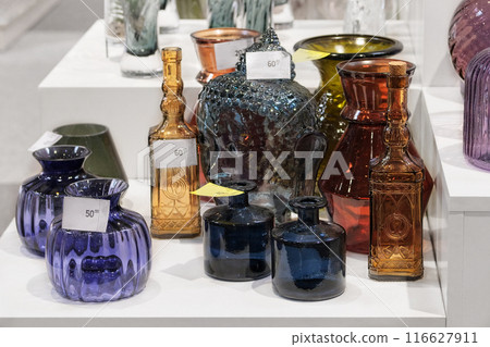 Variety of glass flower vases are sold in store. Jars for flowers. Variety of glass flower vases are sold in store. Jars for flowers. 116627911
